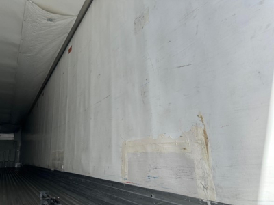 Trailer interior side wall with patch repair and white epoxy patch on aluminum surface, cargo area of 2018 Utility Air Ride 3000R trailer.