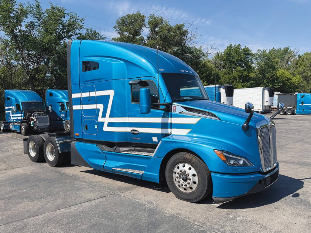 Kenworth T680 Next Gen tractor shown in blue with white graphics, side view, front cab and sleeper area visible.