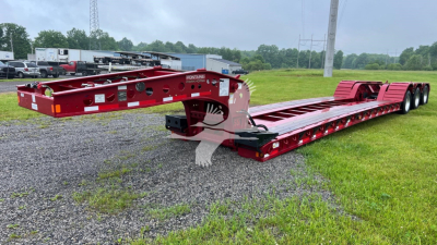 Trailer chassis showing a red Fontaine 55 LCC lowboy trailer with multiple axles and a long deck, side rails, and wheel wells. Visible text includes Fontaine branding on the frame.