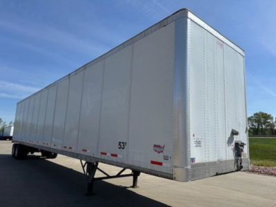 Trailer side and front showing a white 53' Wabash van semi-trailer with landing gear and nose guard.
