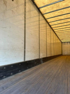 Interior of a 2014 Wabash van trailer showing empty cargo area with wooden floor and side walls.