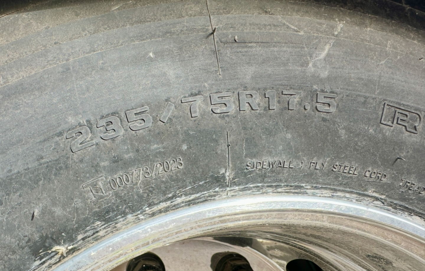 Tire sidewall with markings: 265/75R17.5 and other small text; close-up of wheel and rim.