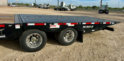 Landoll 930E-51-15 flatbed trailer showing rear wheel and 930E decal on black frame with red/white reflective tape
