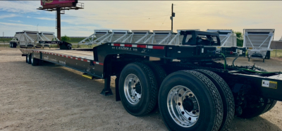 Landoll 930E-51-15 trailer chassis with dual rear axles, black frame, long flatbed, branded markings visible.