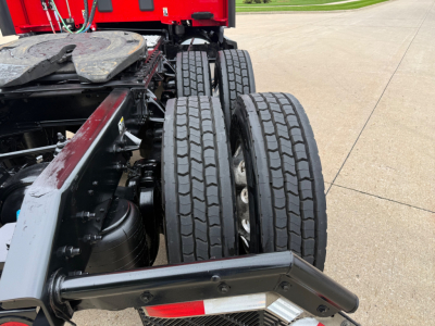 Kenworth T680 chassis with dual rear axles and fuel tank, visible tires and frame. No legible labels or fluid markings readable.