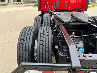 Kenworth T680 chassis and rear dual rear tires view showing drivetrain frame and fuel tanks.