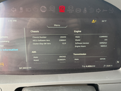 Truck dashboard display showing chassis and engine information with ECU software version, engine hours, and transmission data.
