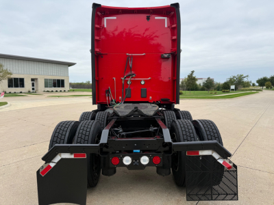 Kenworth T680 rear view showing chassis and fifth wheel area with mudflaps and linkages