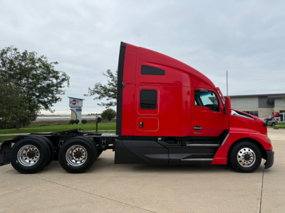 Kenworth T680 semi truck side profile in red with sleeper cab and chrome wheels. Visible text includes model badge 'Kenworth' on cab, and the image shows no legible VIN/sticker text.