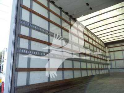 Truck box interior showing aluminum cross-members and wood floor with side walls, empty cargo area.
