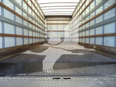 Truck cargo area interior showing empty box body with side walls and wooden runners.