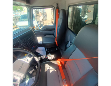 Mack GR84F cabin interior showing front seats and orange seat belts.