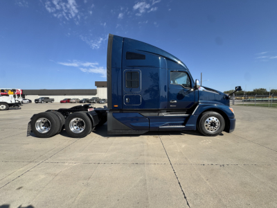 Kenworth T680 tractor side view showing sleeper cab and dual rear axles with chrome wheels