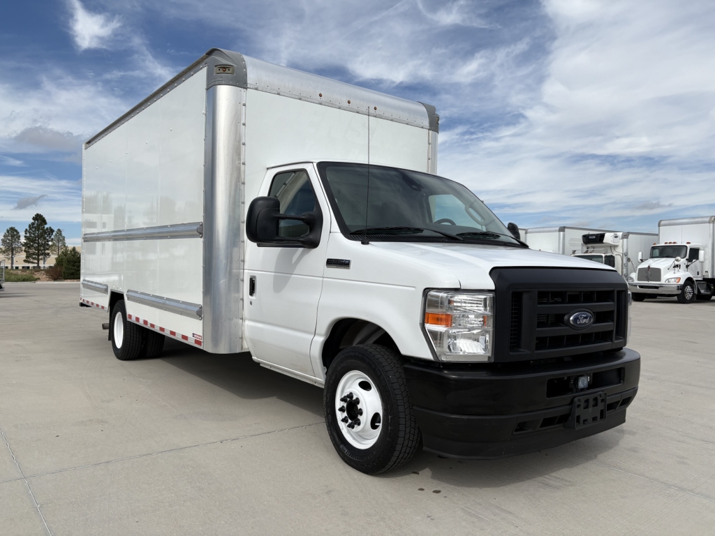 Ford E-350 box truck in service bay showing white cargo box and black front bumper with Ford emblem.