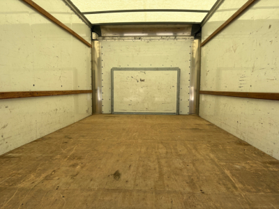 Ford E-350 cargo box interior showing empty box with wooden side walls and metal floor.