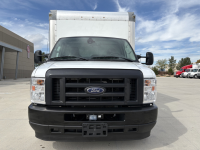 Ford E-Series box truck front view showing black grille, Ford emblem, large side mirrors, and cargo box behind cab.