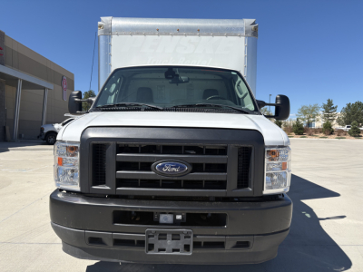 Ford E-350 front view showing grille with Ford emblem and black bumper, box truck cargo area in background.