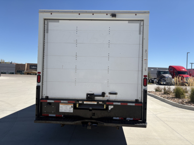 Ford E350 box truck rear view showing cargo area door and bumper with safety decals.