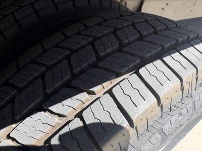 Tire tread close-up on 2022 Ford E350 chassis in the cargo area, showing heavy-duty dual rear tires and tread pattern.