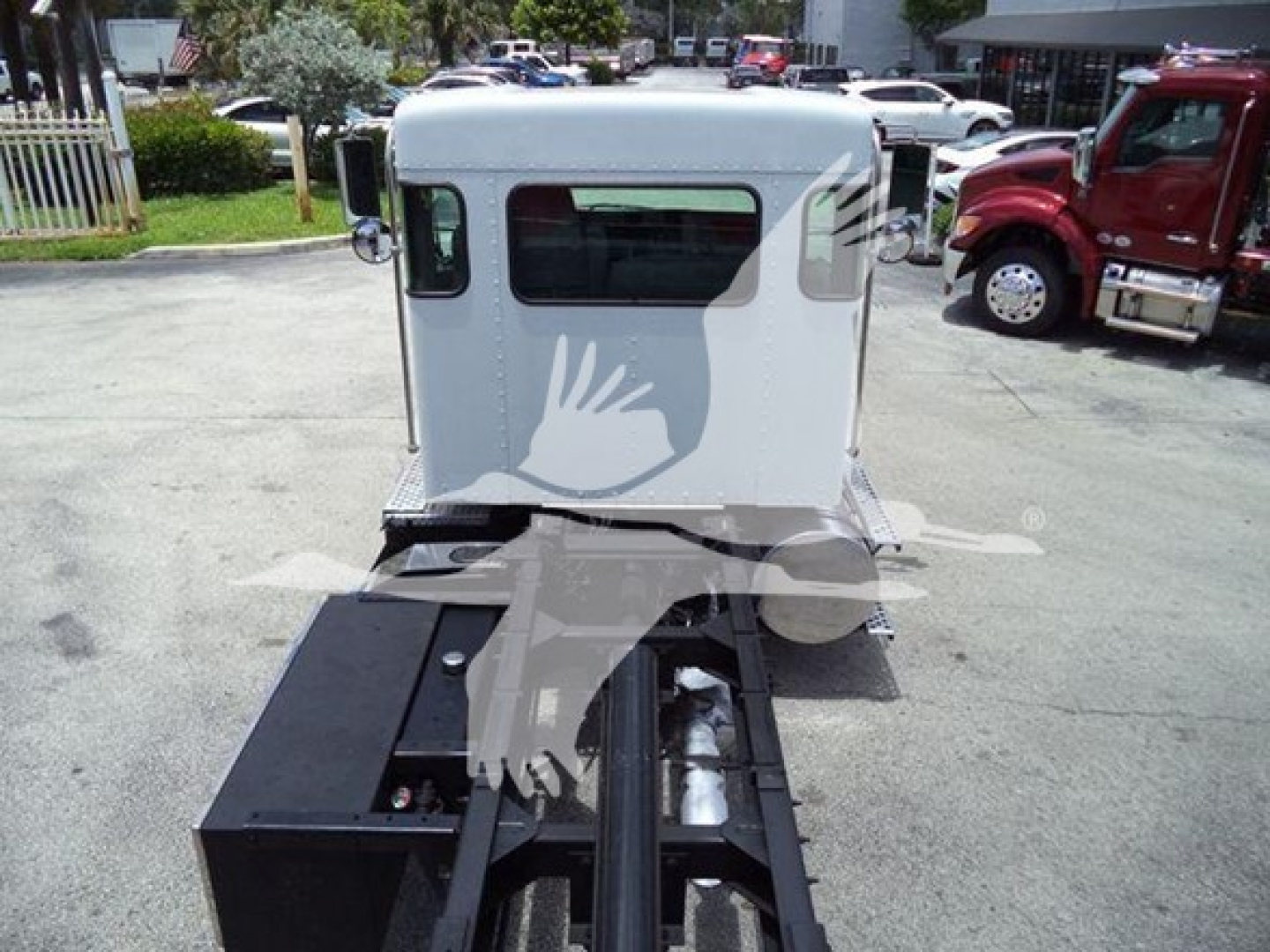 Truck cab of a 2019 Kenworth T270 with a rollback body, silver/gray cab, rear view showing towing chassis and winch area.