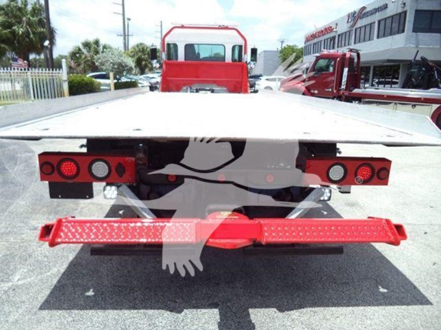 Kenworth T270 rollback rear view showing flatbed, red rear bumper guard, and tail lights.