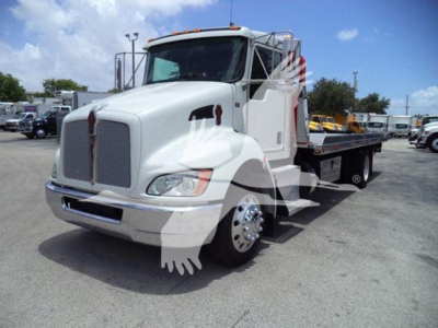 White 2019 Kenworth T270 rollback tow truck shown at angle with long flatbed, chrome grille, and Kenworth emblem; banner watermark overlay on image.