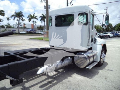 Truck cab and chassis of a Kenworth T270 rollback truck showing fuel tank, exhaust, and chassis frame.