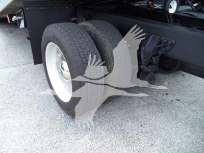 Rear dual wheels and suspension of a 2019 Kenworth T270 rollback truck showing dual rear tires and chassis.