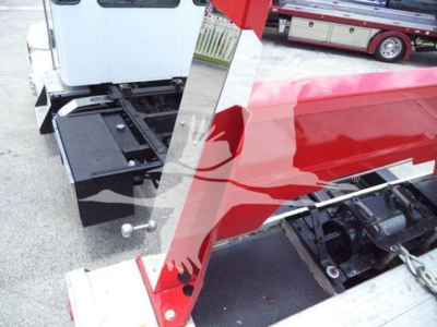 Kenworth T270 rollback truck showing hydraulic hitch area and chassis with engine bay components visible.