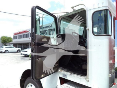 Truck cab interior showing open door of a Kenworth T270 rollback truck.