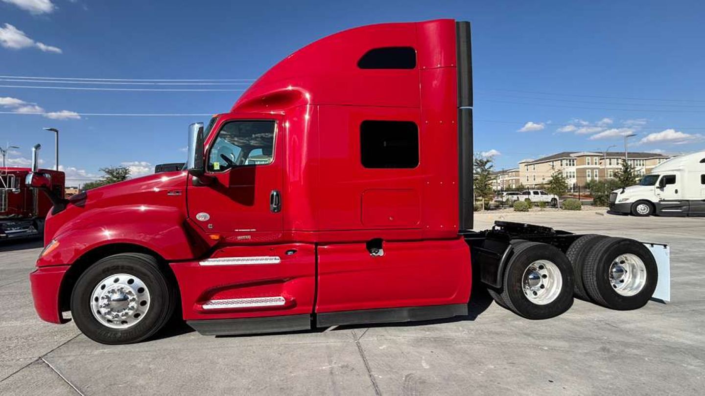 Red 2022 International LT625 conventional sleeper tractor in side profile view showing cab with windows and dual rear axles.