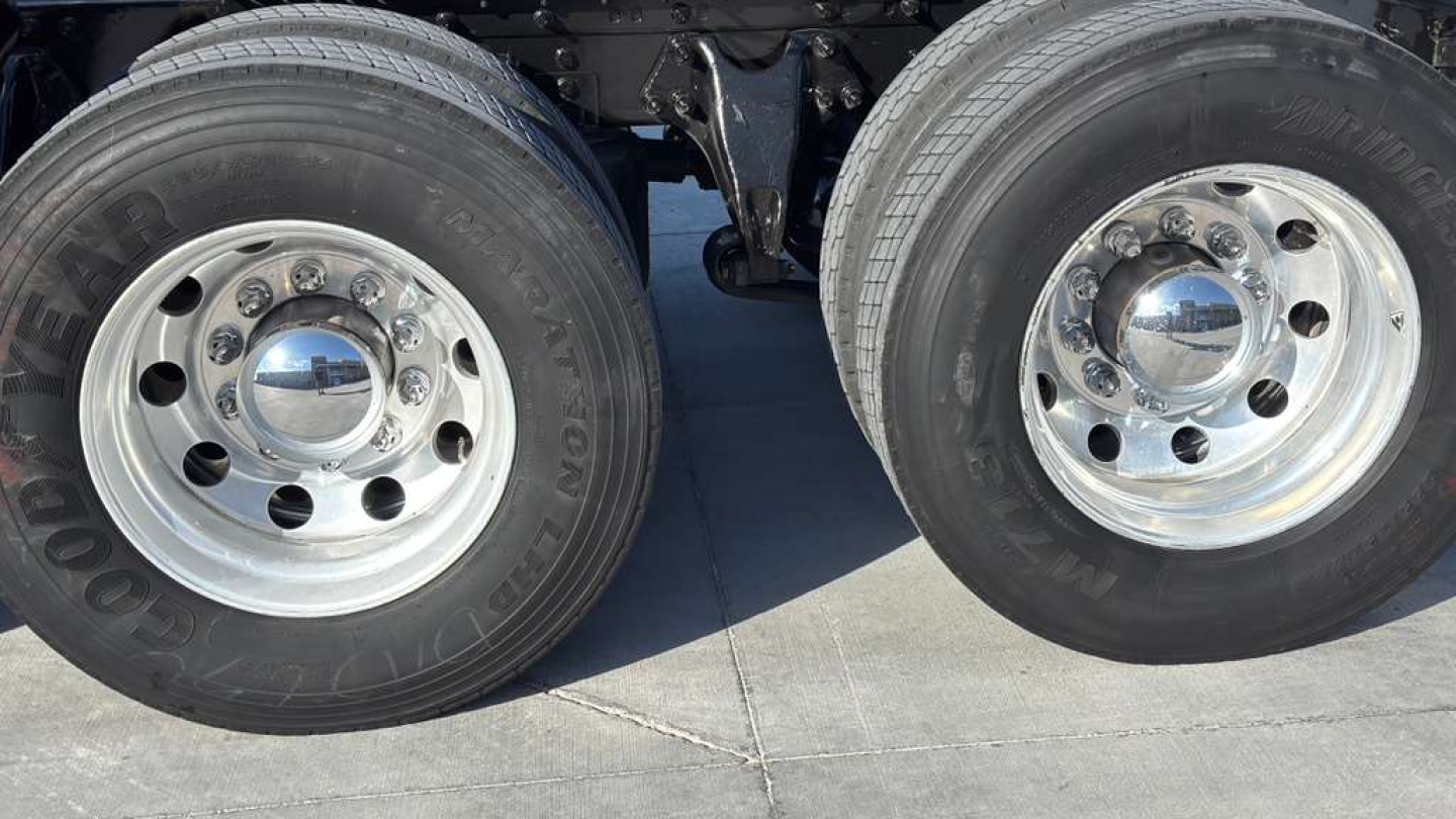 Dual rear wheels showing Goodyear tires and chrome hubcaps on a 2022 International LT625 truck.