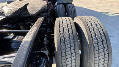 Truck chassis with dual rear axles and tires visible, part of a 2022 International LT625 listed used.