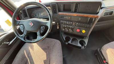 Interior cockpit of a 2022 International LT625 truck with steering wheel, dashboard, and center console showing numerous controls and gauges.