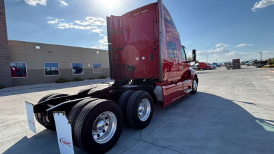 Truck cab of a red 2022 International LT625 tractor with sleeper configuration, rear view shows wheels and fifth wheel area.