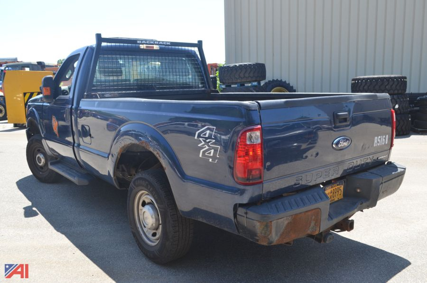 Ford F-250 Super Duty pickup truck rear-left view showing tailgate with 'F-250' badge and bumper, spare tire on bed, and 'SUPER DUTY' on tailgate.