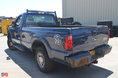 Ford F-250 Super Duty pickup truck rear-left view showing tailgate with 'F-250' badge and bumper, spare tire on bed, and 'SUPER DUTY' on tailgate.