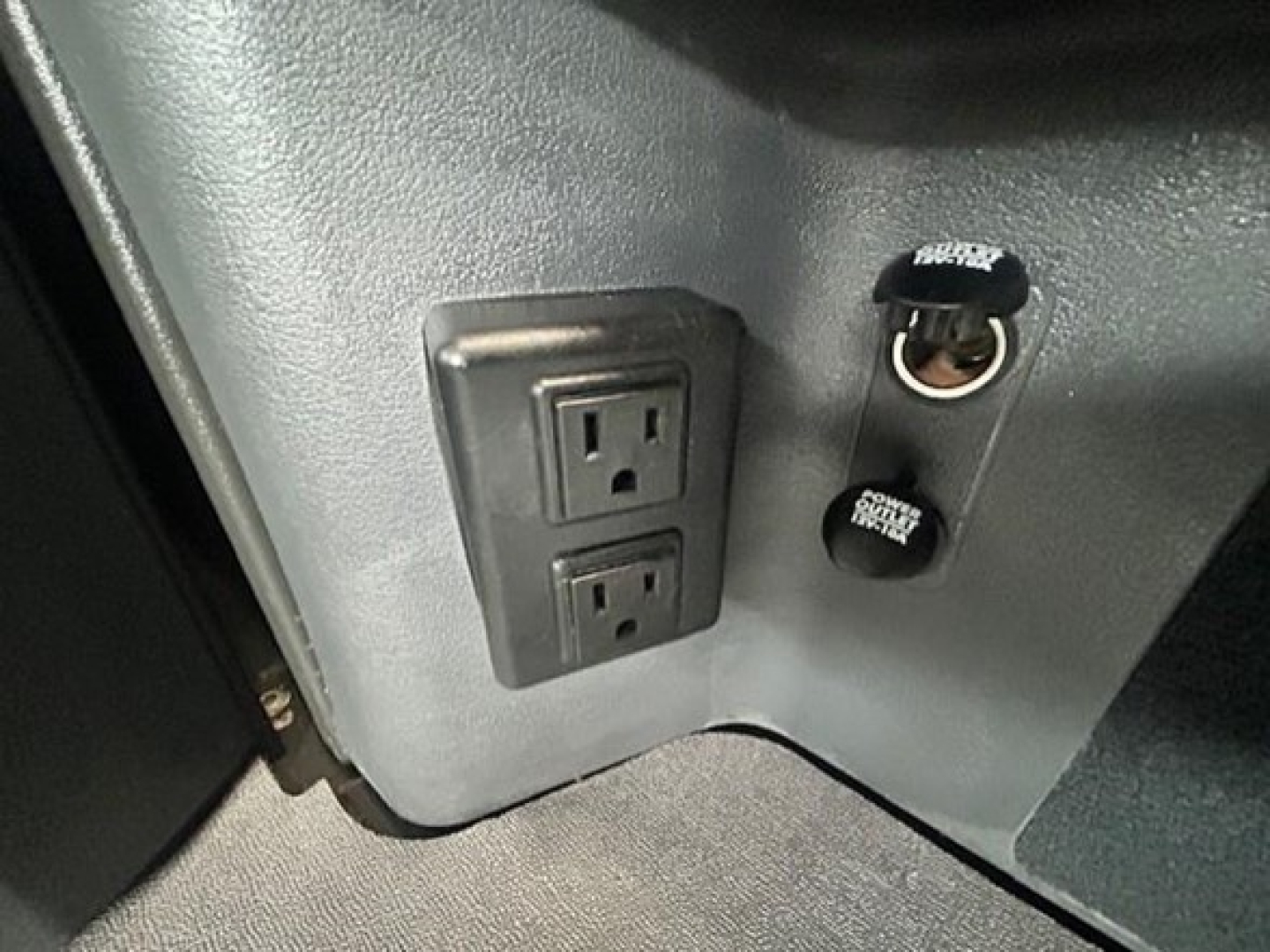 Interior view showing dual power outlets and 12V DC cigarette lighter sockets on Freightliner Cascadia dash panel.