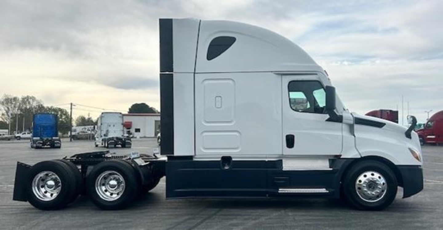 Truck side view showing 2024 Freightliner Cascadia 126 sleeper cab with dual rear axles and white paint, VIN 3AKJHHDR8RSUT6706.