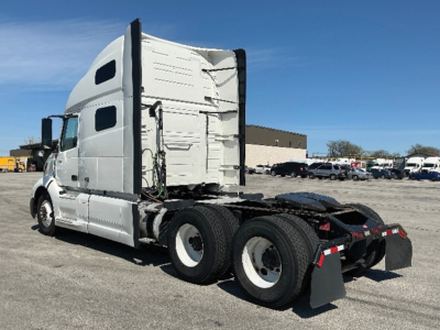 Volvo VNL 760 sleeper tractor with white exterior, rear view showing dual rear axles and fifth-wheel, no visible cab details.