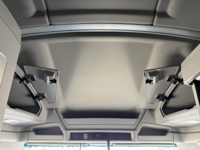 Kenworth T680 cab interior ceiling view with overhead panels and sun visors.