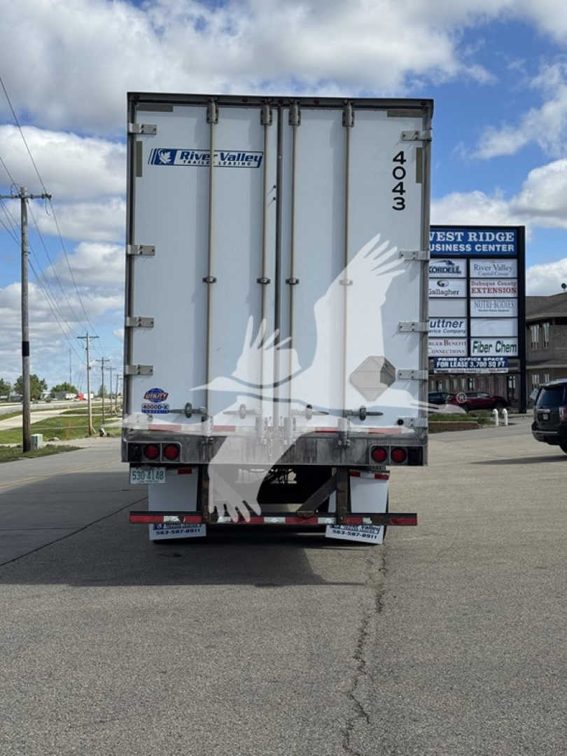 Rear of a 2014 Utility 4000Dx trailer showing River Valley logo and 4043 number on doors; tail lights and bumper visible.