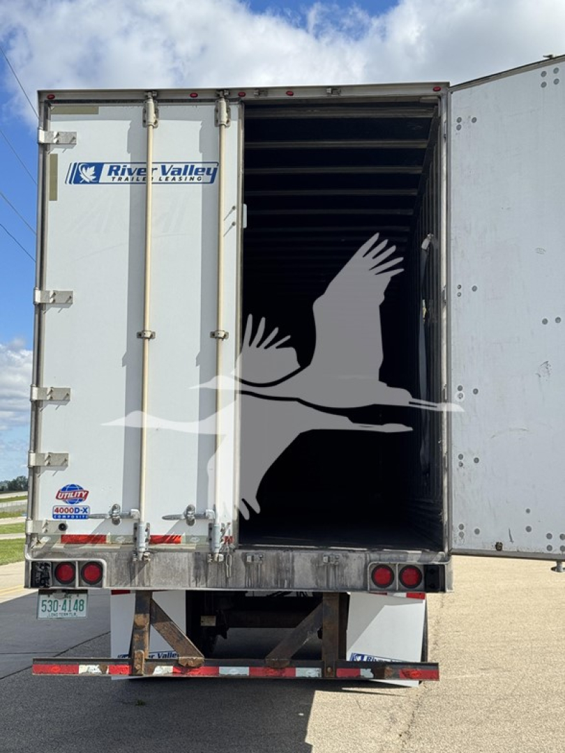 Rear view of a 2014 Utility 4000Dx trailer with open rear doors showing interior cargo space. River Valley logo on left door, bumper and tail lights visible, license plate area.