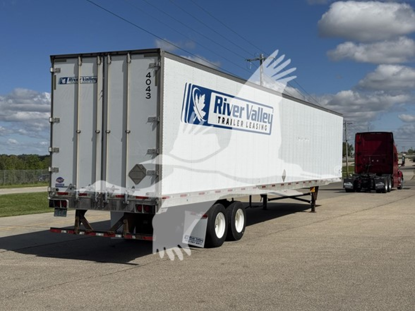 Utility trailer back and side view showing River Valley Trailer Leasing logo and rear doors; number 4043 on doors; dual rear tires.