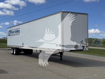 Trailer showing River Valley branding on side, tandem axle, 2014 Utility 4000Dx trailer, aluminum walls, elevated front jack, in a parking lot.