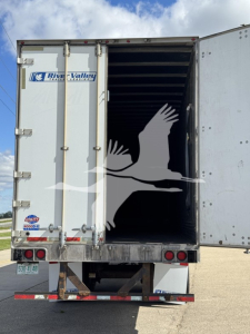 Rear view of a 2014 Utility 4000Dx trailer with open rear doors showing interior cargo space. River Valley logo on left door, bumper and tail lights visible, license plate area.
