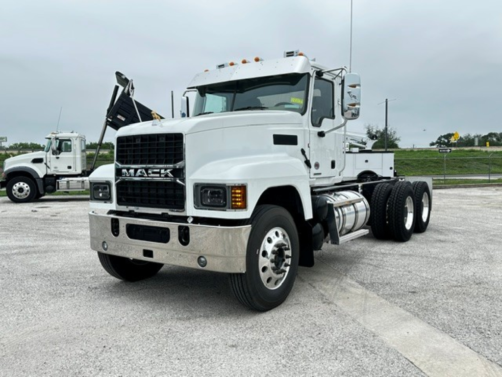 Mack PI64 cab and chassis truck in white showing front grille with Mack badge and dual rear wheel configuration.