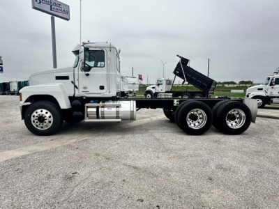 Mack PI64 cab and chassis truck side view showing white tractor with dump bed option and dual rear axles.