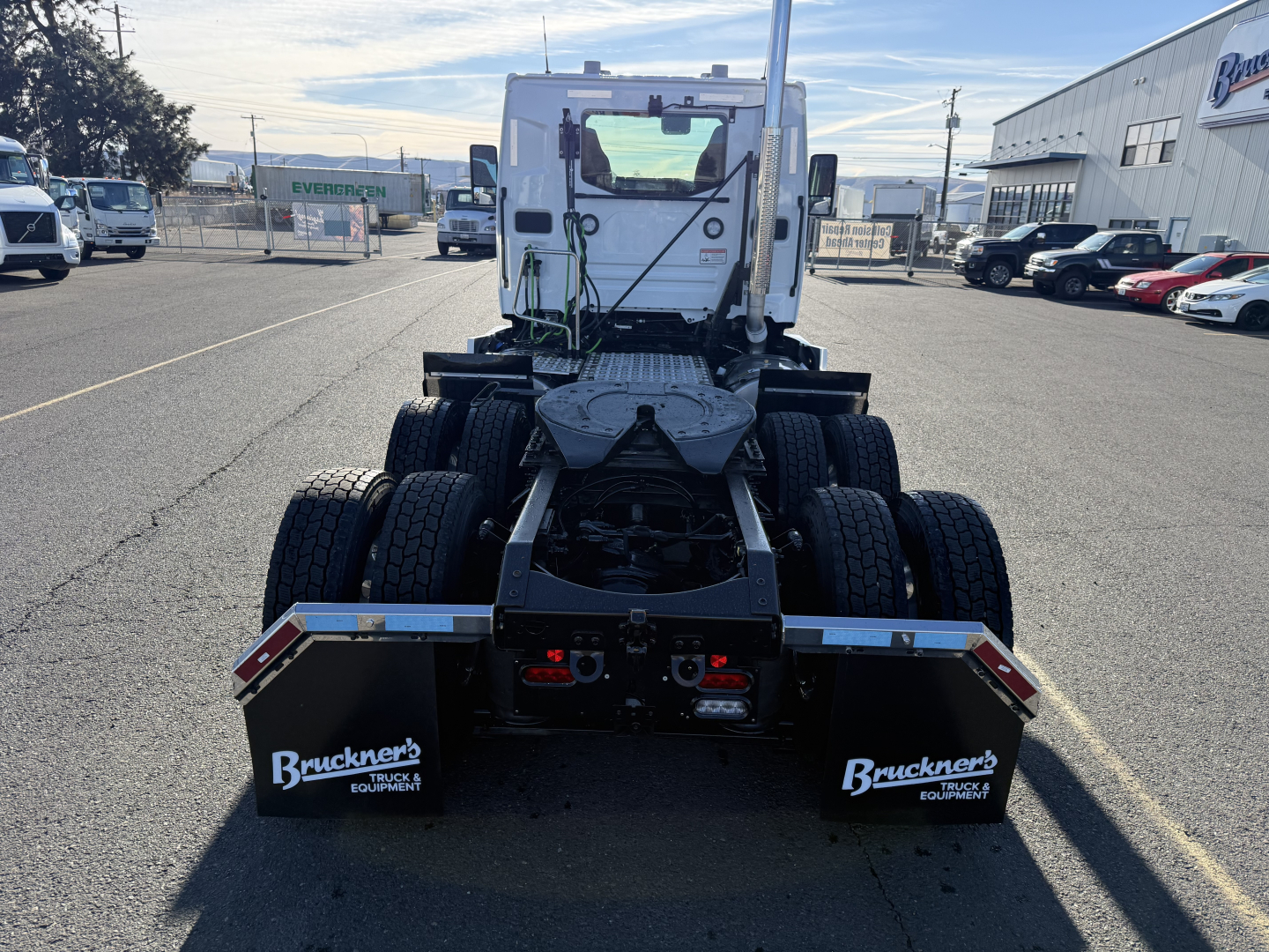 Truck rear view showing fifth wheel and dual rear axles on a new Mack PR64T cab chassis.