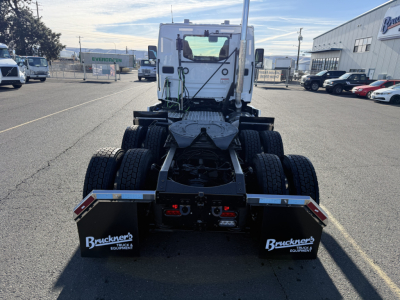 Truck rear view showing fifth wheel and dual rear axles on a new Mack PR64T cab chassis.